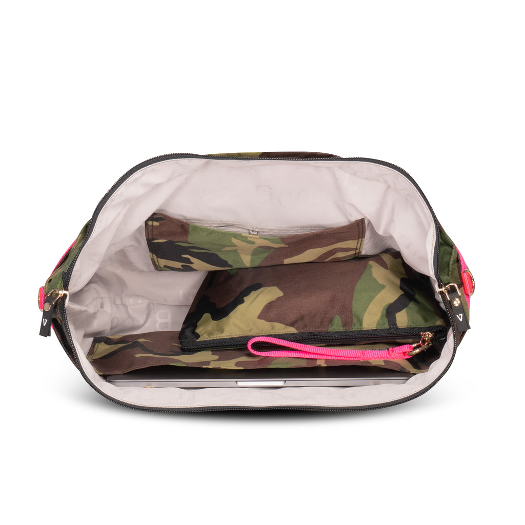 Inside view of ANDI camo bag showing inner pockets, laptop compartment and snap-out wristlet pouch