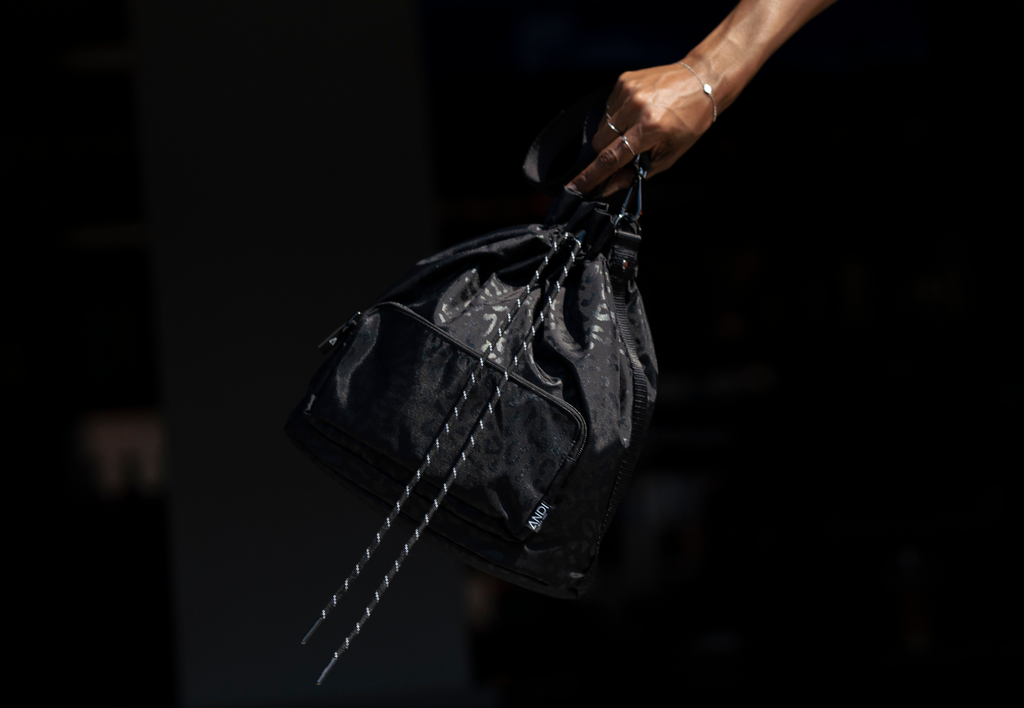 ANDI nylon bucket cross-body bag in black leopard print