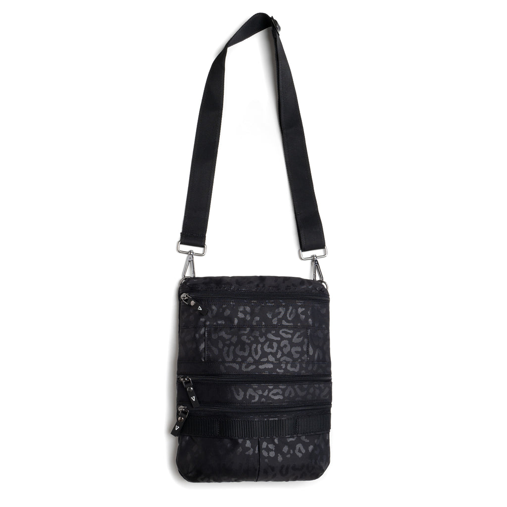 Water resistant Black Leopard ANDI crossbody belt bag that expands to triple the carrying capacity