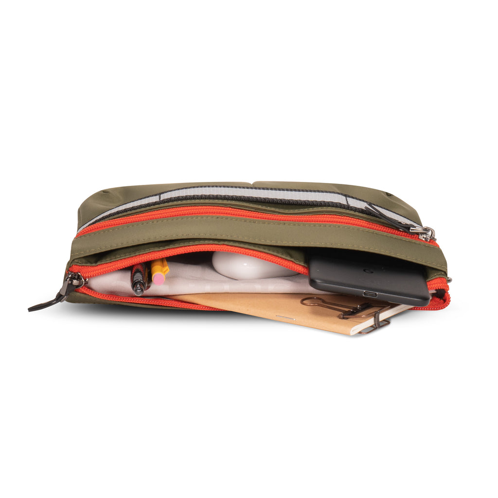 Convertible small handheld purse in sage green with orange zippers | ANDI Brand