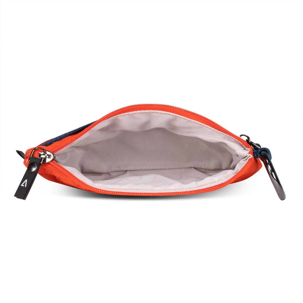 Inside of ANDI convertible pouch in orange color with blue webbing