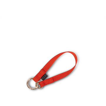 Mini polyester key leash in orange color that also functions as a wristlet strap | ANDI 