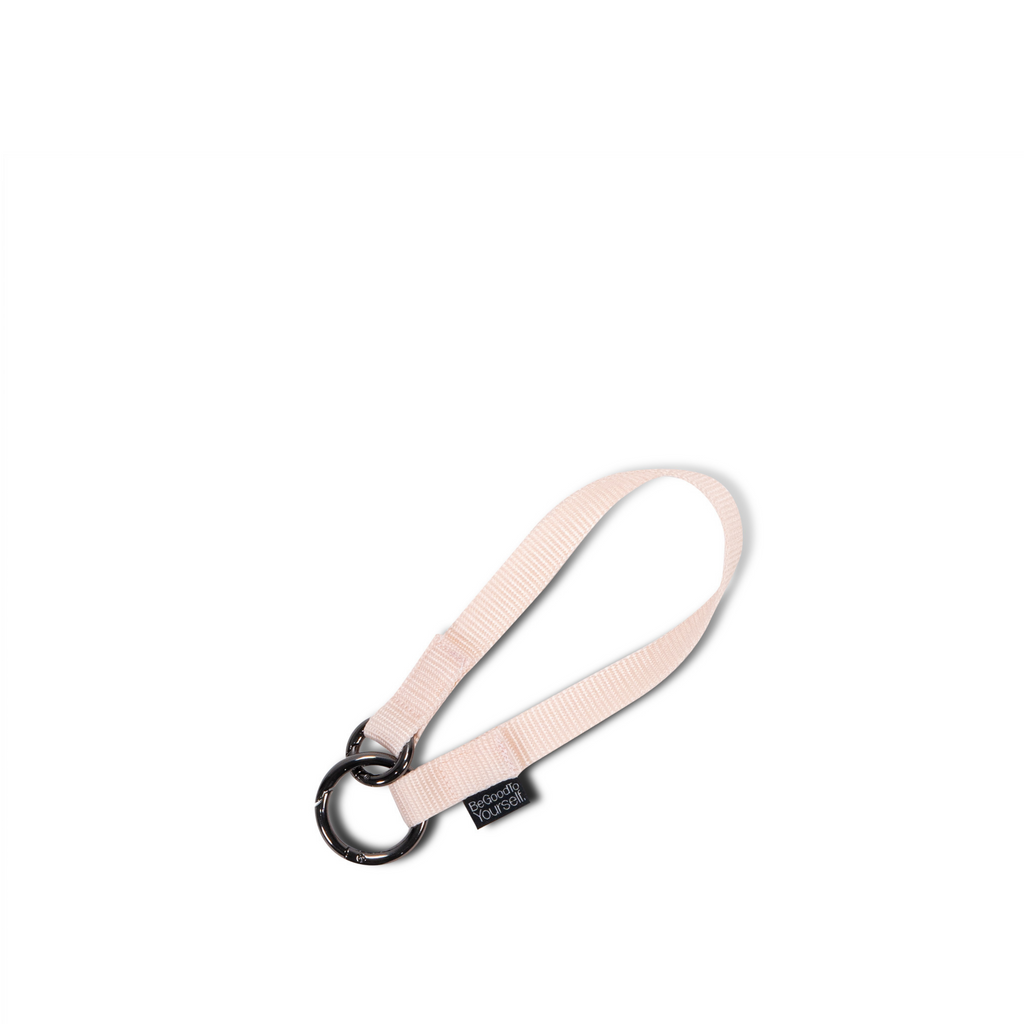 Light pink nylon wristlet strap that can attach to any ring or strap on your bag | ANDI