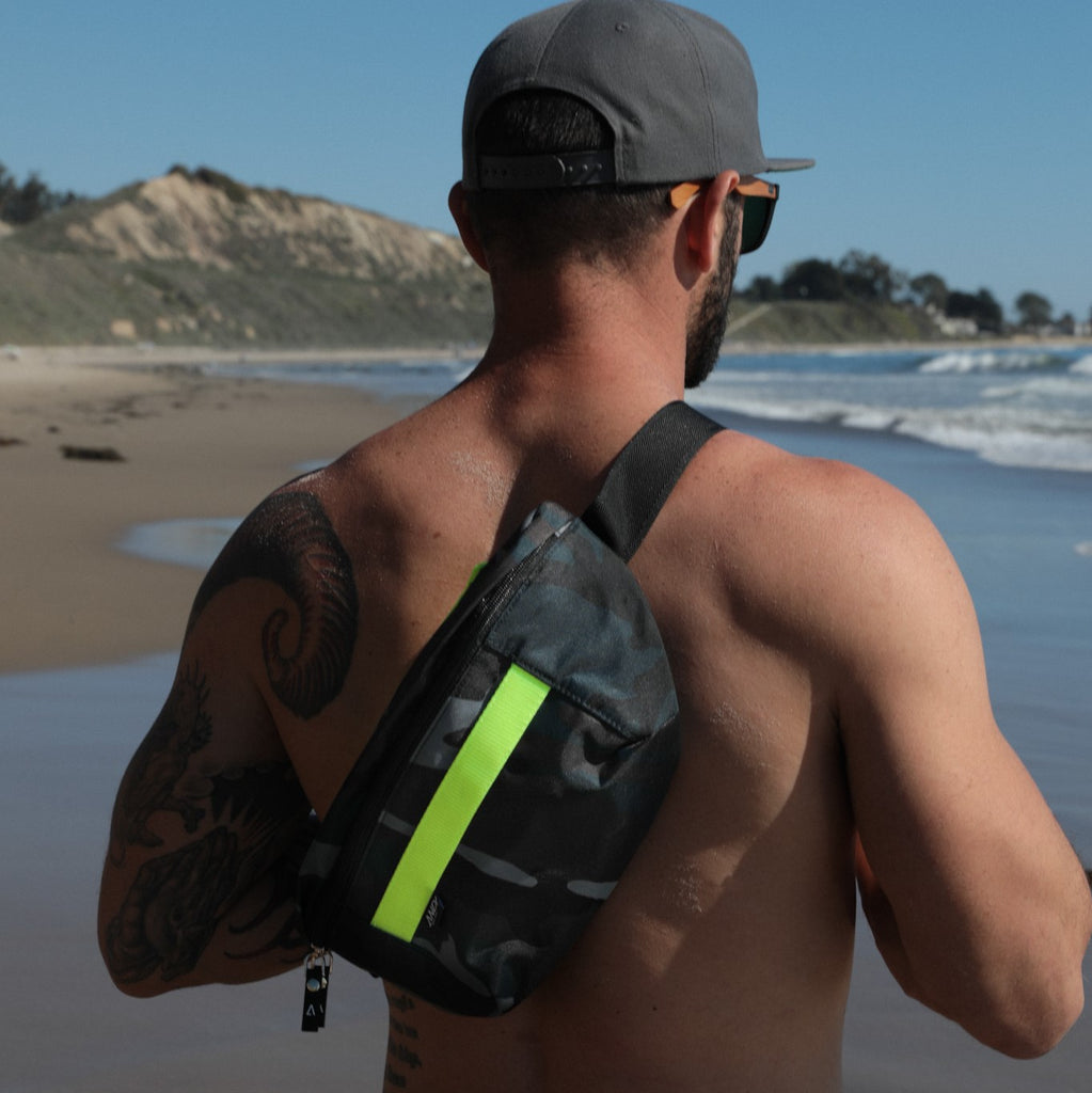 Man wearing ANDI fanny pack in blue camo across his back | Neon Yellow | Water resistant nylon