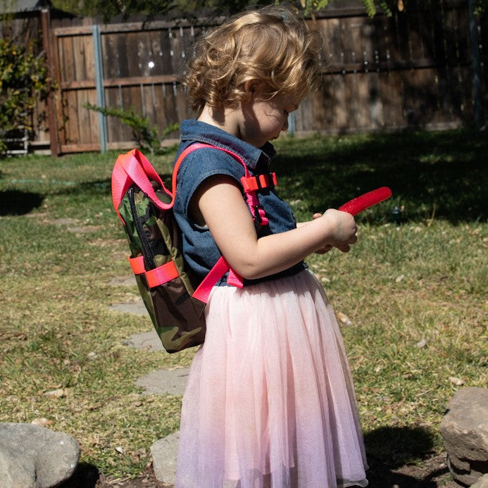 Girl wearing small kids backpack in camouflage with hot pink straps | ANDI Brand