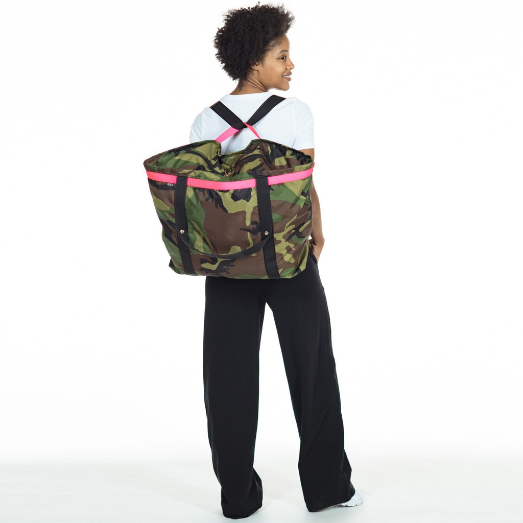 Woman wearing extra large ANDI Weekender travel bag in backpack style