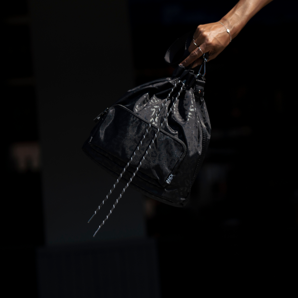 Stylish nylon bucket bag in black leopard print | water resistant gym bag | ANDI Brand