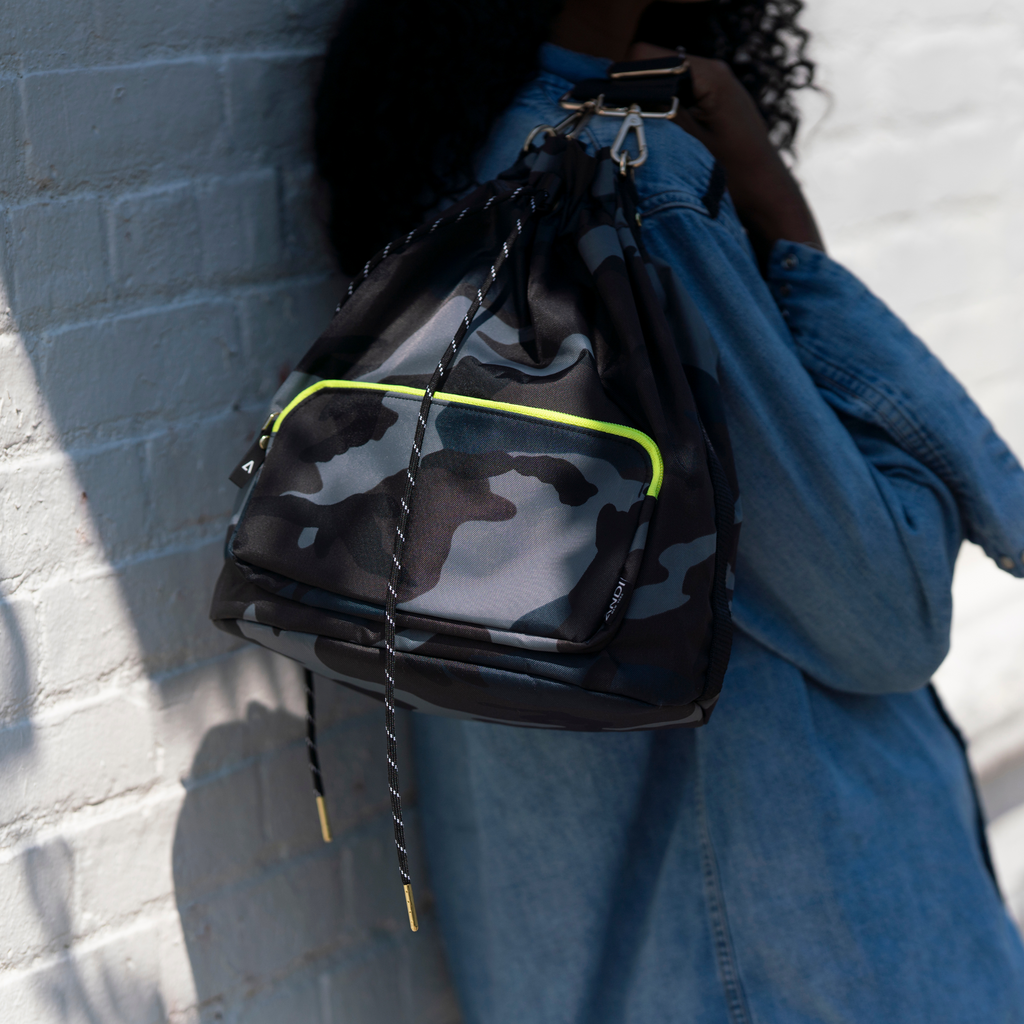Women holding blue camo nylon bucket bag | Neon Yellow | ANDI Brand